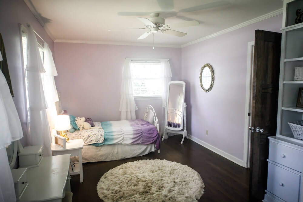 lavender kids room with carpet, ceiling fan and bed