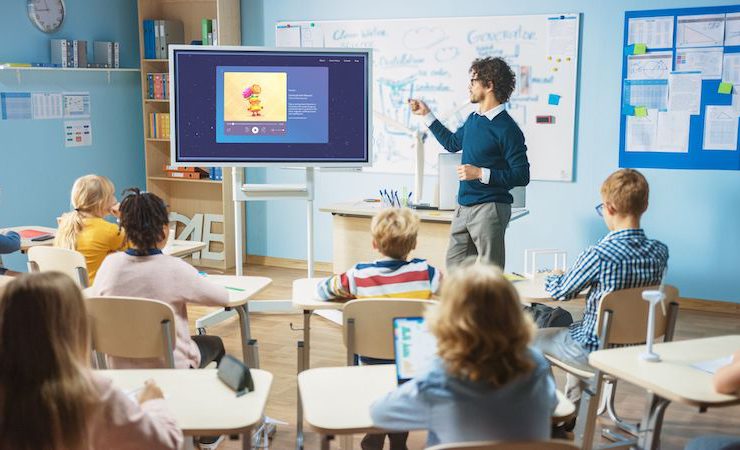 teacher managing classroom with Moshi for schools on the screen